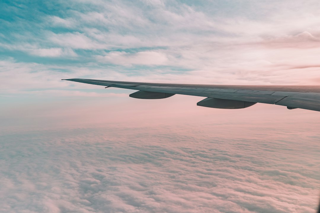 Airplane wing above the clouds on a flight from Canada