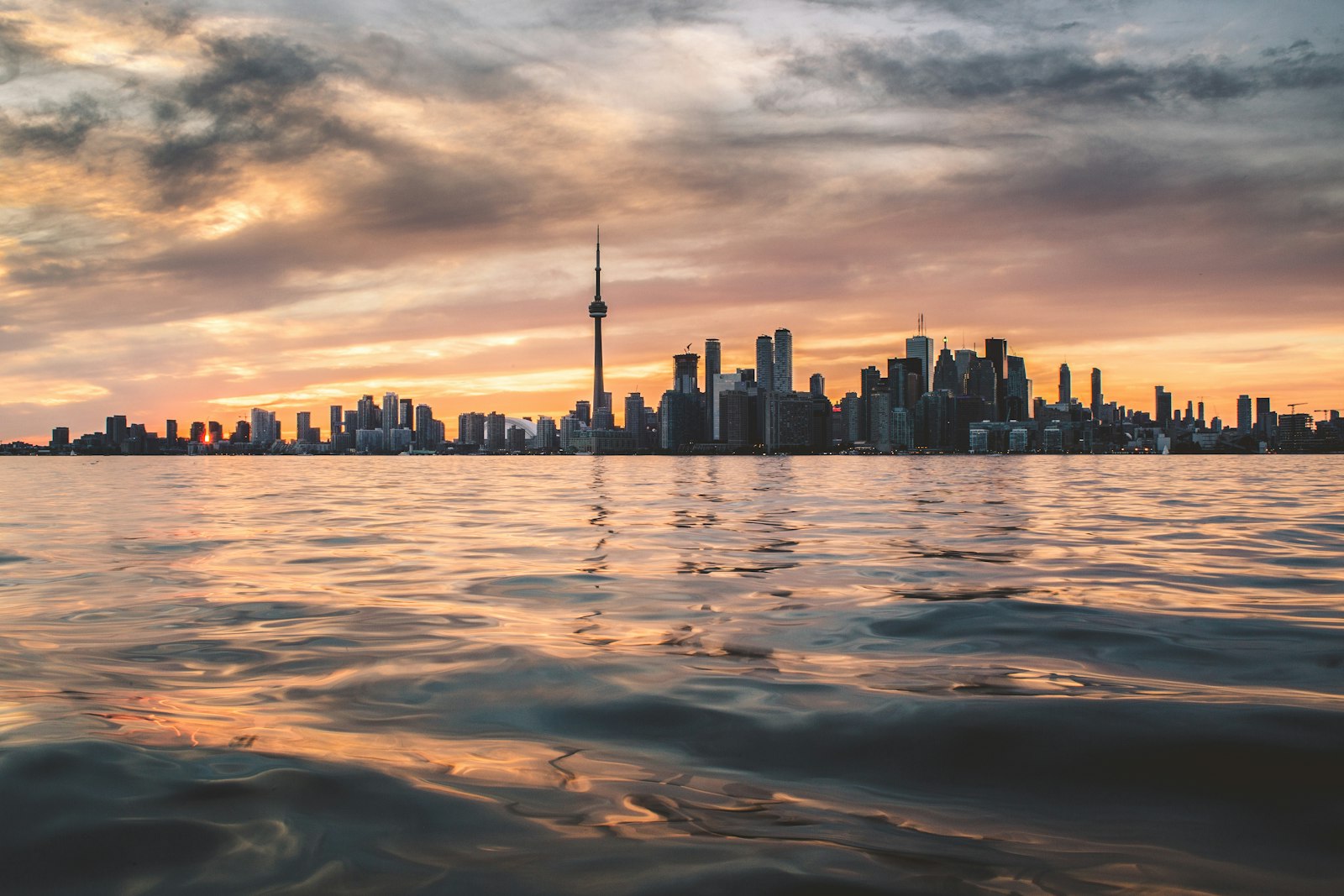 Toronto skyline with the CN Tower across Lake Ontario at golden hour